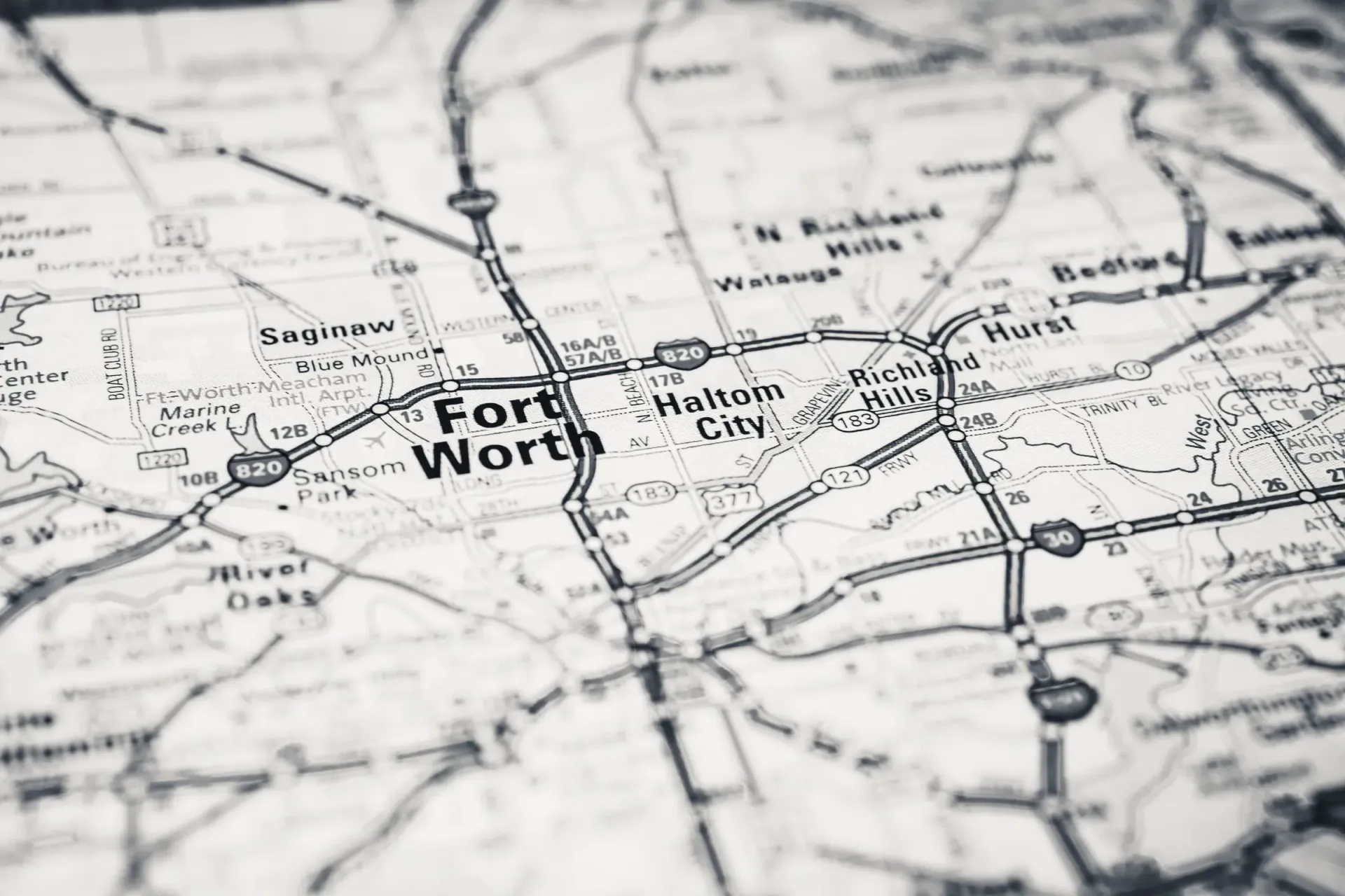 Close view of a printed road map centered on Fort Worth, showing Saginaw, Haltom City, Richland Hills, Hurst, and Bedford along Loop 820
